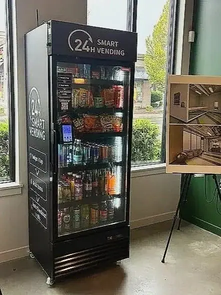 HAHA 24-hour smart vending cooler stocked with drinks and snacks in a building lobby
